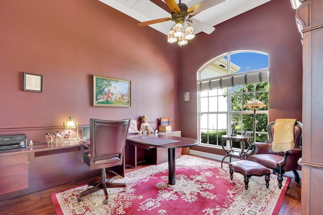 home office with high vaulted ceiling, ceiling fan, and dark hardwood / wood-style floors