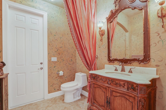 bathroom with toilet, tile floors, and vanity