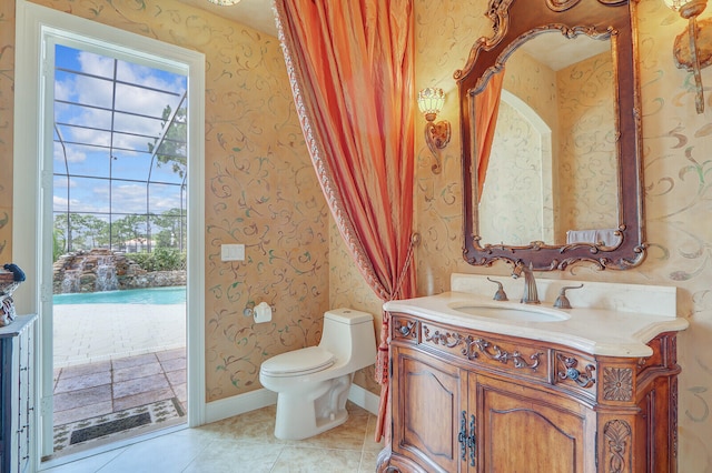 bathroom featuring toilet, tile floors, and vanity