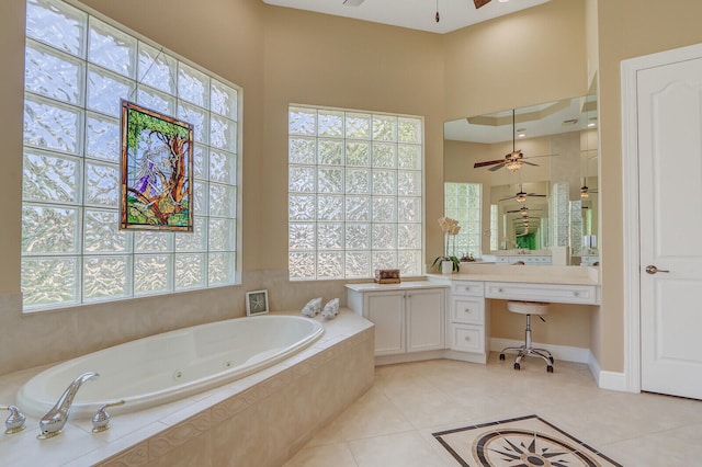 bathroom featuring vanity, tiled tub, tile flooring, and ceiling fan