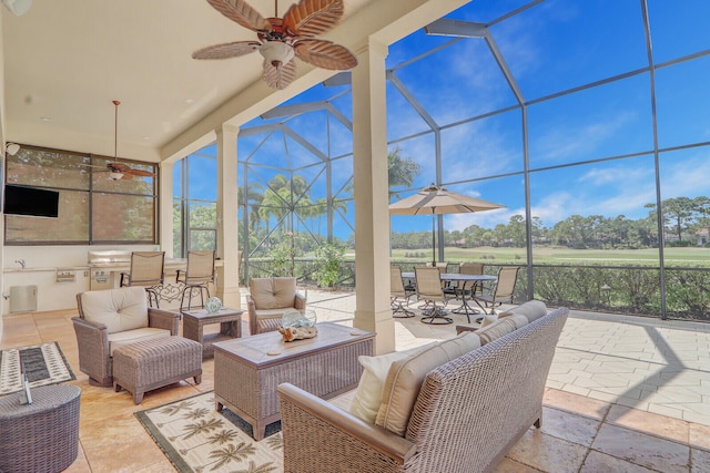 sunroom / solarium featuring ceiling fan and plenty of natural light