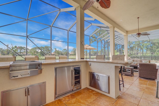 view of terrace with glass enclosure, outdoor lounge area, an outdoor kitchen, area for grilling, and ceiling fan