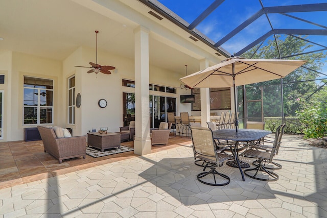 view of patio / terrace featuring glass enclosure, ceiling fan, and an outdoor hangout area