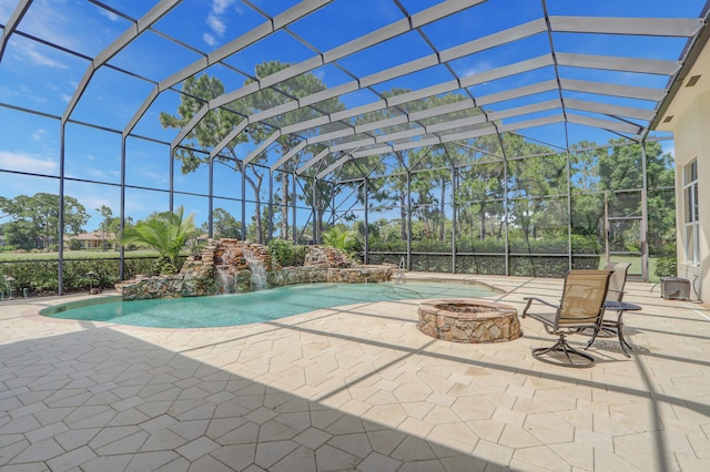 view of swimming pool featuring glass enclosure, pool water feature, and a patio area