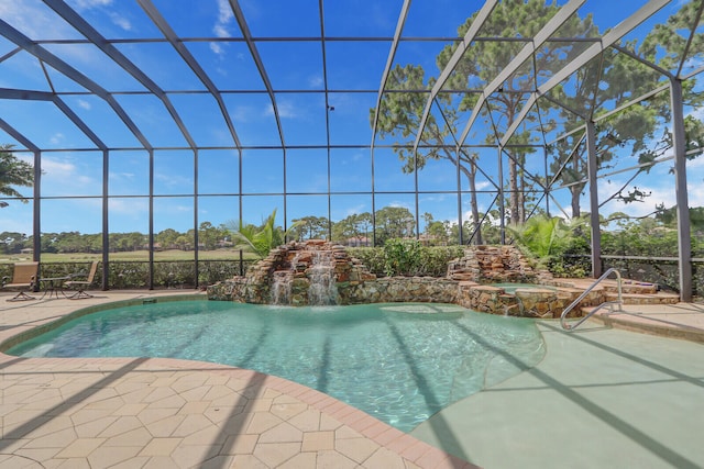 view of swimming pool with a patio area, pool water feature, an in ground hot tub, and glass enclosure