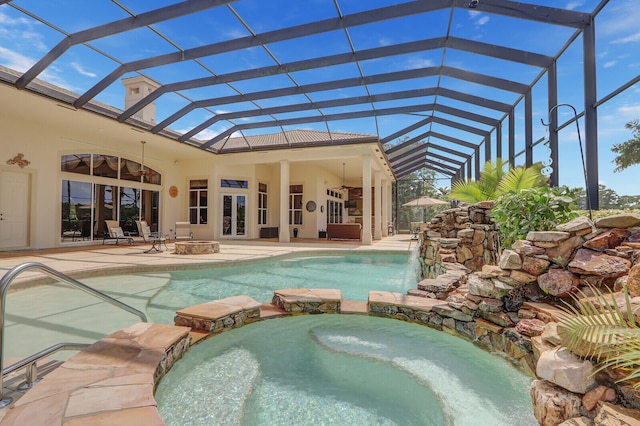 view of swimming pool with a patio area, french doors, glass enclosure, and an in ground hot tub