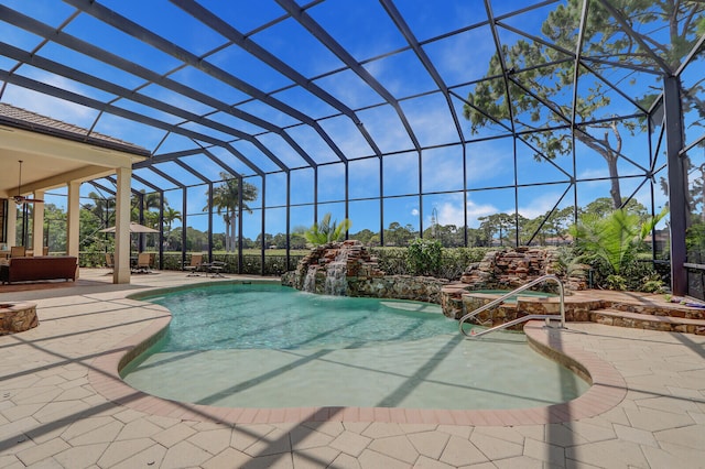 view of pool featuring glass enclosure, pool water feature, and a patio area