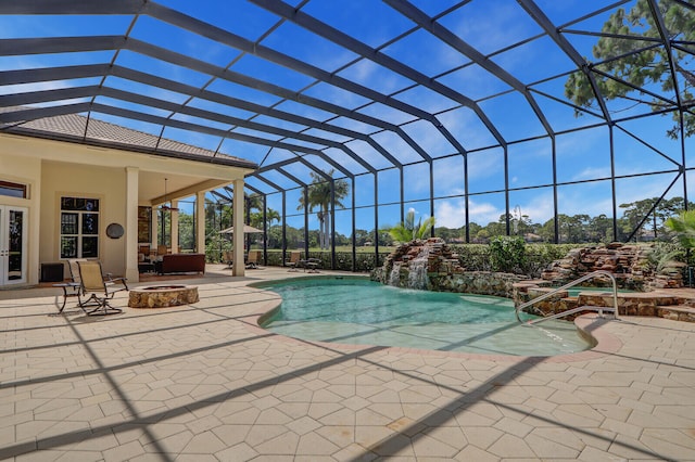 view of swimming pool featuring a patio area, ceiling fan, a lanai, and pool water feature