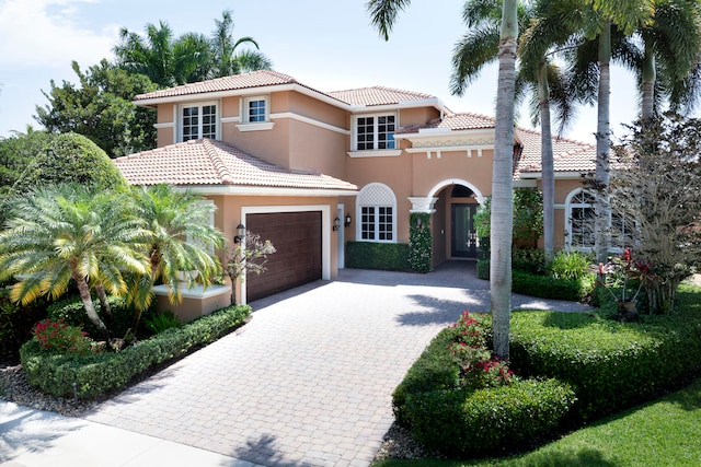 mediterranean / spanish-style house featuring a garage