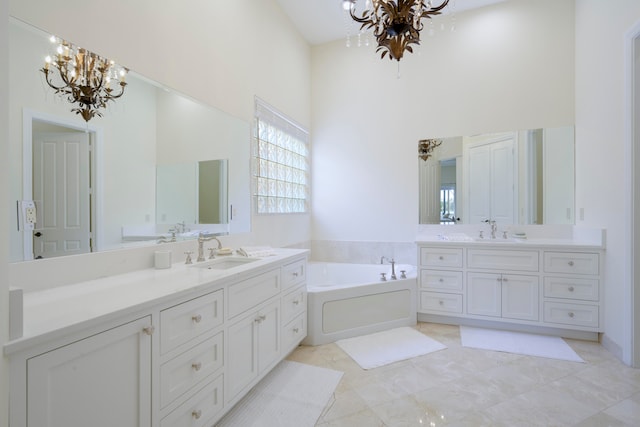 bathroom with an inviting chandelier, a bath to relax in, tile flooring, large vanity, and high vaulted ceiling