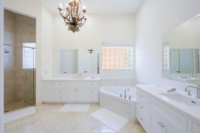 bathroom featuring shower with separate bathtub, tile flooring, a chandelier, and large vanity