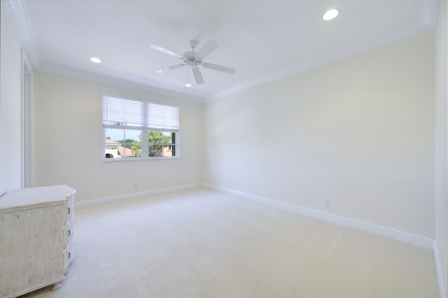 empty room with ornamental molding, carpet flooring, and ceiling fan