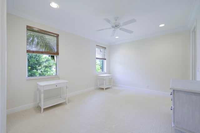 empty room featuring ceiling fan, a wealth of natural light, and ornamental molding