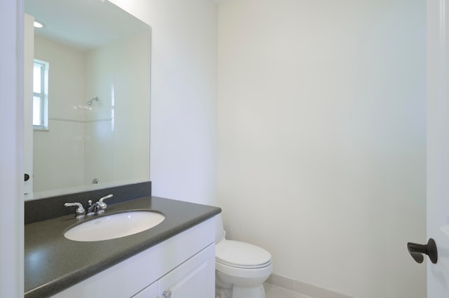 bathroom featuring vanity with extensive cabinet space and toilet