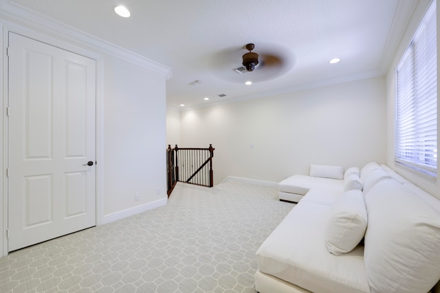 living room with ceiling fan and crown molding