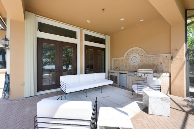 view of terrace featuring french doors, an outdoor kitchen, and grilling area