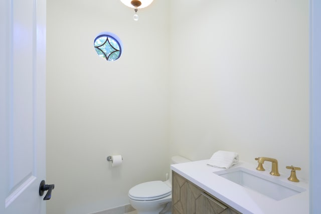 bathroom featuring toilet and vanity