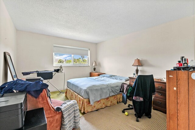 carpeted bedroom with a textured ceiling