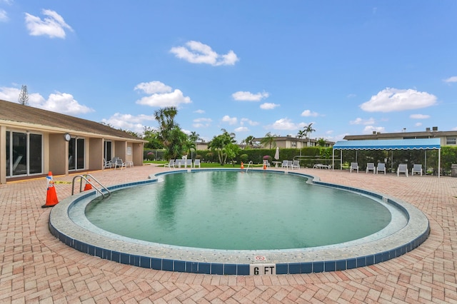 view of swimming pool featuring a patio area