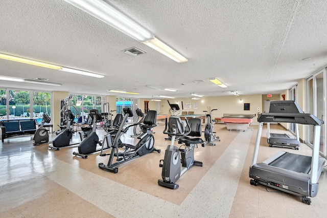 exercise room with pool table and a textured ceiling