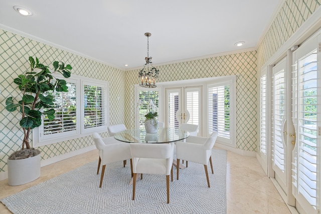 dining room with a notable chandelier, light tile floors, and ornamental molding