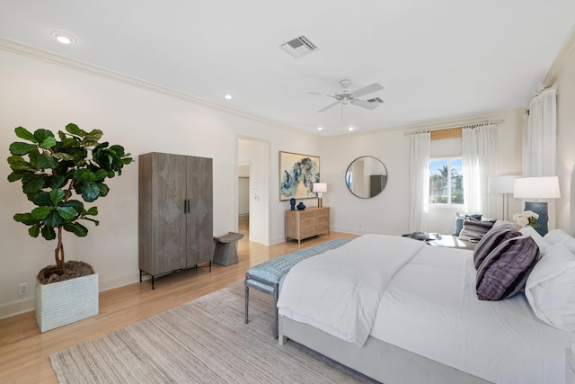 bedroom with light hardwood / wood-style flooring, ceiling fan, and crown molding