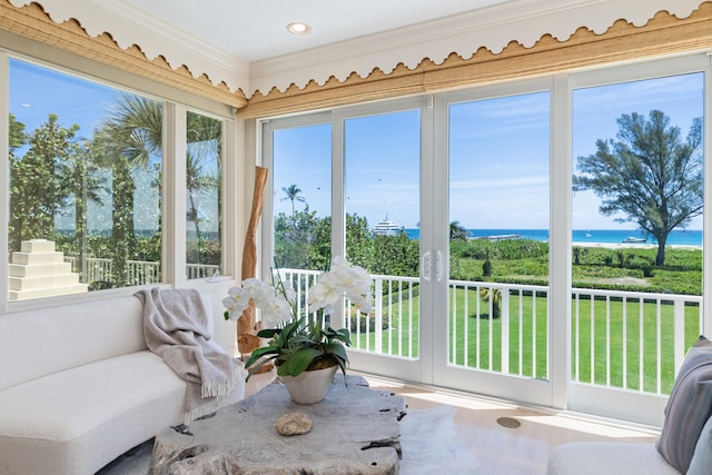 sunroom / solarium featuring a water view and a wealth of natural light