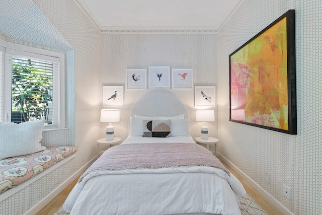 bedroom with wood-type flooring and crown molding