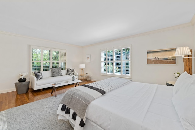 bedroom with crown molding, wood-type flooring, and multiple windows