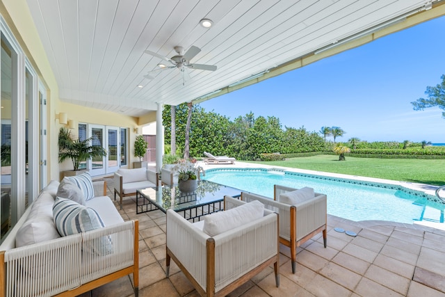 view of swimming pool featuring an outdoor living space, ceiling fan, and a patio area