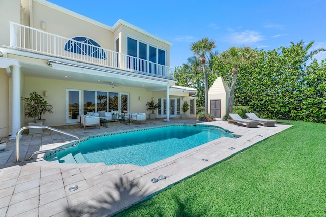 view of swimming pool featuring a lawn, outdoor lounge area, ceiling fan, and a patio area