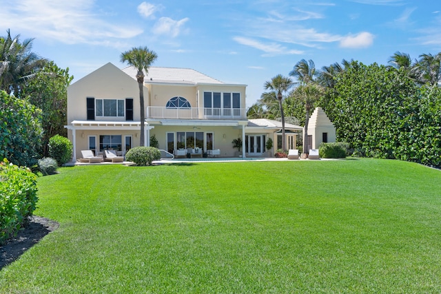 back of property featuring a lawn, a patio, and a pergola