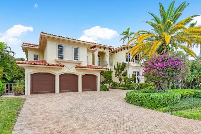 mediterranean / spanish-style home with a garage