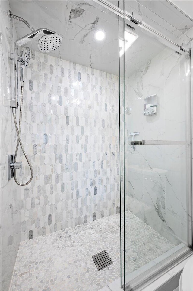 bathroom featuring a shower with shower door