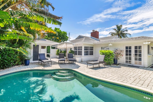 view of pool featuring a patio area and french doors