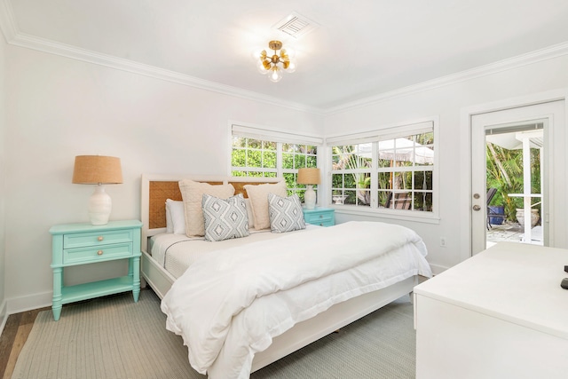 bedroom featuring dark hardwood / wood-style floors, access to exterior, and crown molding