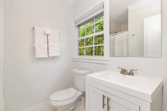 bathroom featuring crown molding, oversized vanity, and toilet