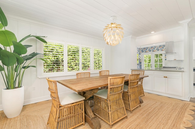 dining space featuring crown molding and a wealth of natural light