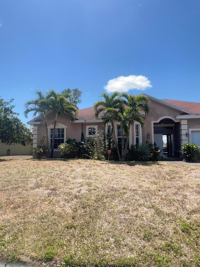 ranch-style house with a front lawn and a garage