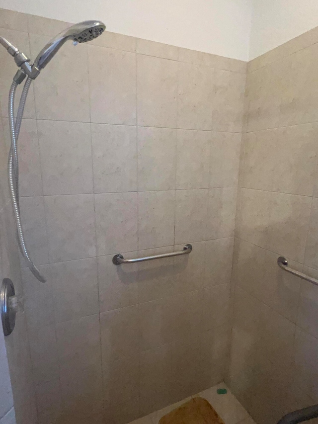 bathroom with a tile shower