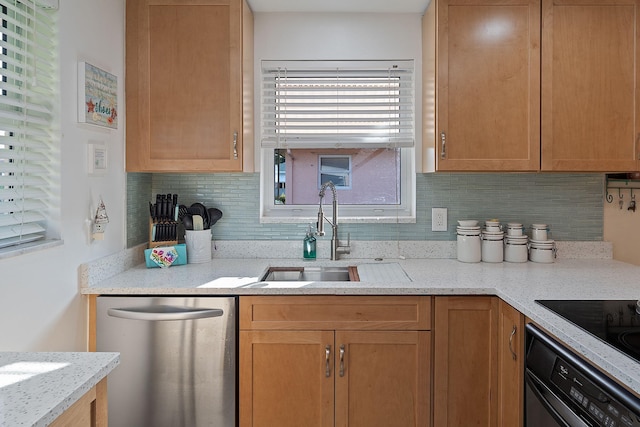 kitchen featuring dishwasher, sink, light stone counters, black oven, and decorative backsplash