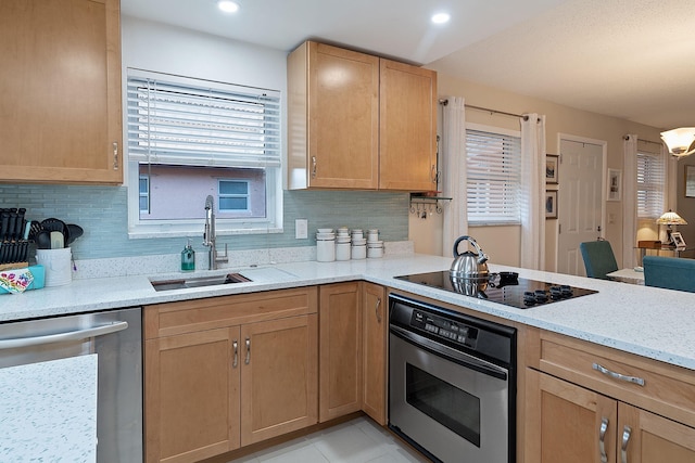 kitchen featuring light stone countertops, appliances with stainless steel finishes, tasteful backsplash, sink, and light tile patterned floors