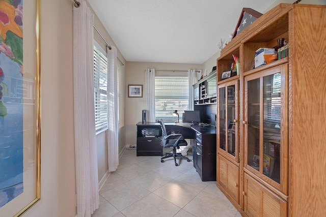 office featuring light tile patterned floors and a textured ceiling