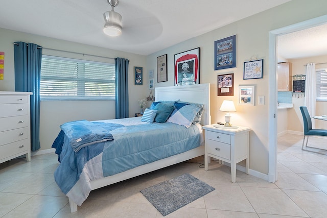 bedroom featuring light tile patterned floors and ceiling fan