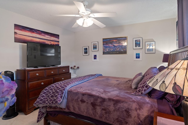 tiled bedroom featuring ceiling fan and a textured ceiling