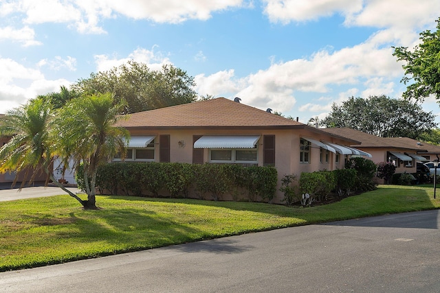 ranch-style house with a front lawn