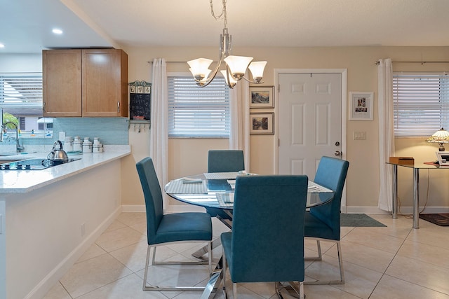 dining area with light tile patterned flooring and a chandelier