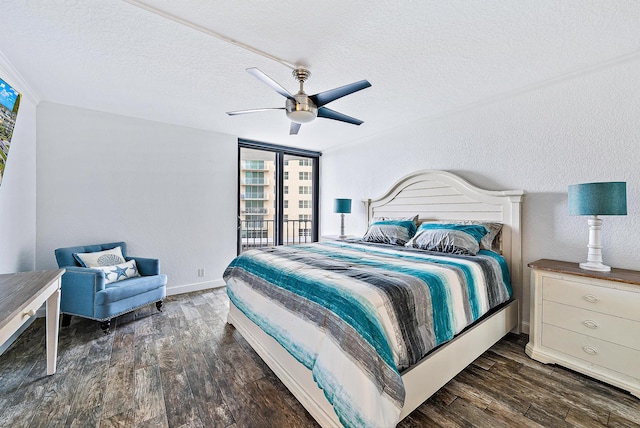 bedroom featuring ceiling fan, dark wood-type flooring, and a textured ceiling