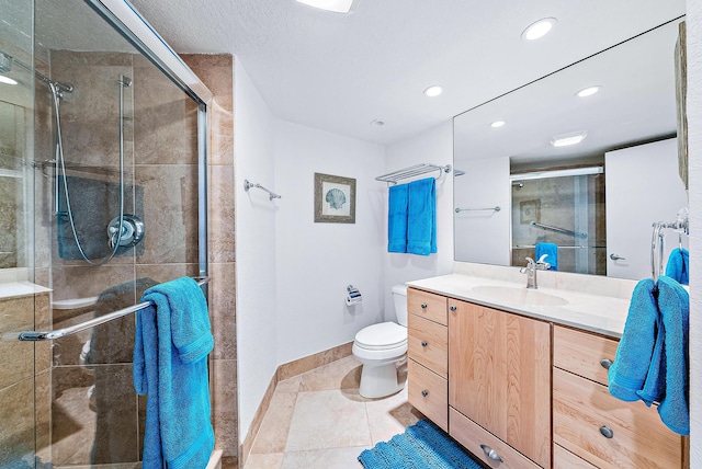 bathroom with an enclosed shower, toilet, tile floors, and vanity