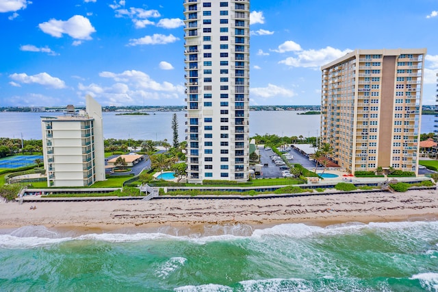 view of building exterior featuring a water view and a view of the beach